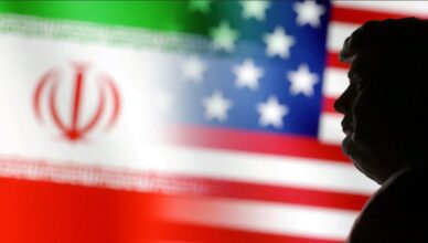 Silhouette of a man's profile against a blurred background showing the Iranian flag and the U.S. flag.